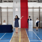 Pani Dyrektor wita uczniów po wakacjach. Obok niej wicedyrektorki oraz uczniowie prowadzący apel